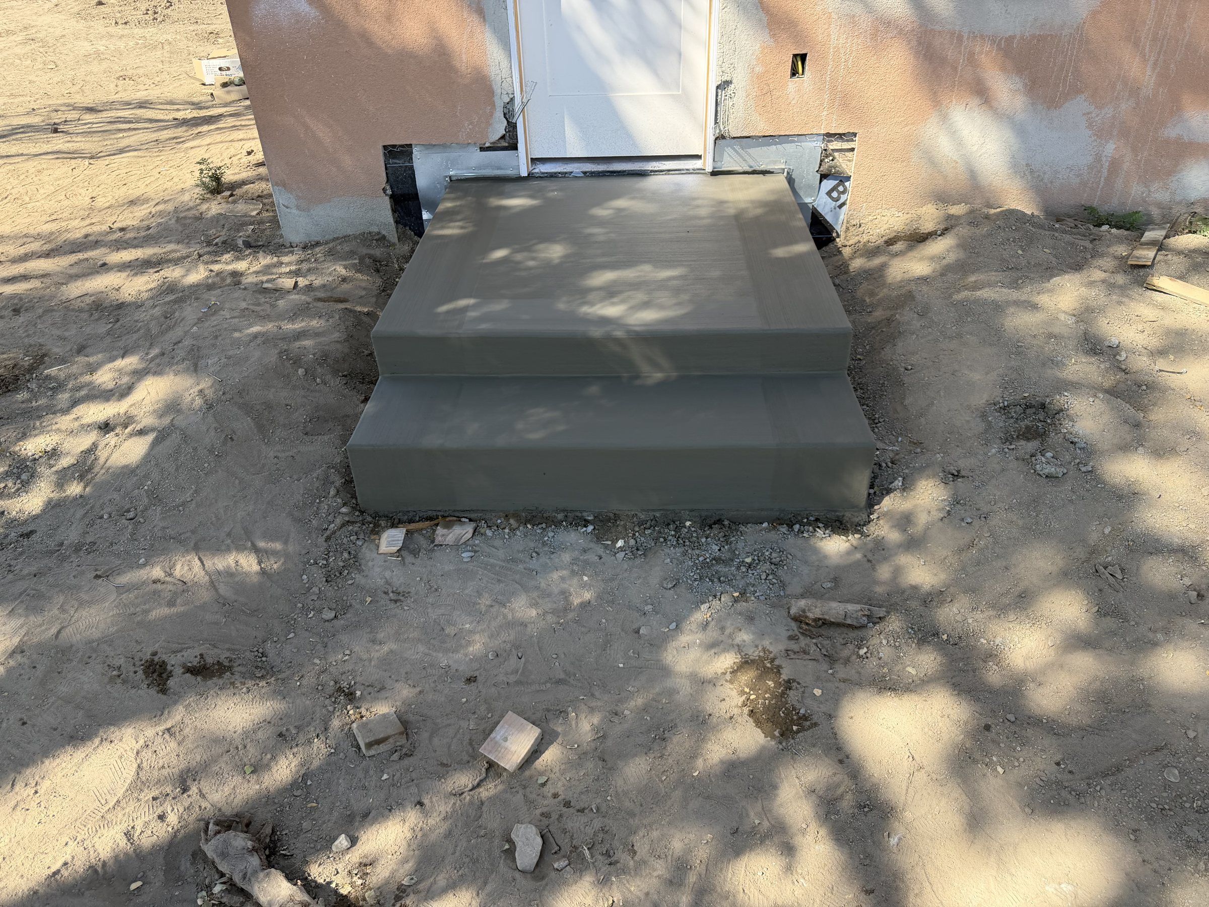 Small concrete stoop and steps at a back door