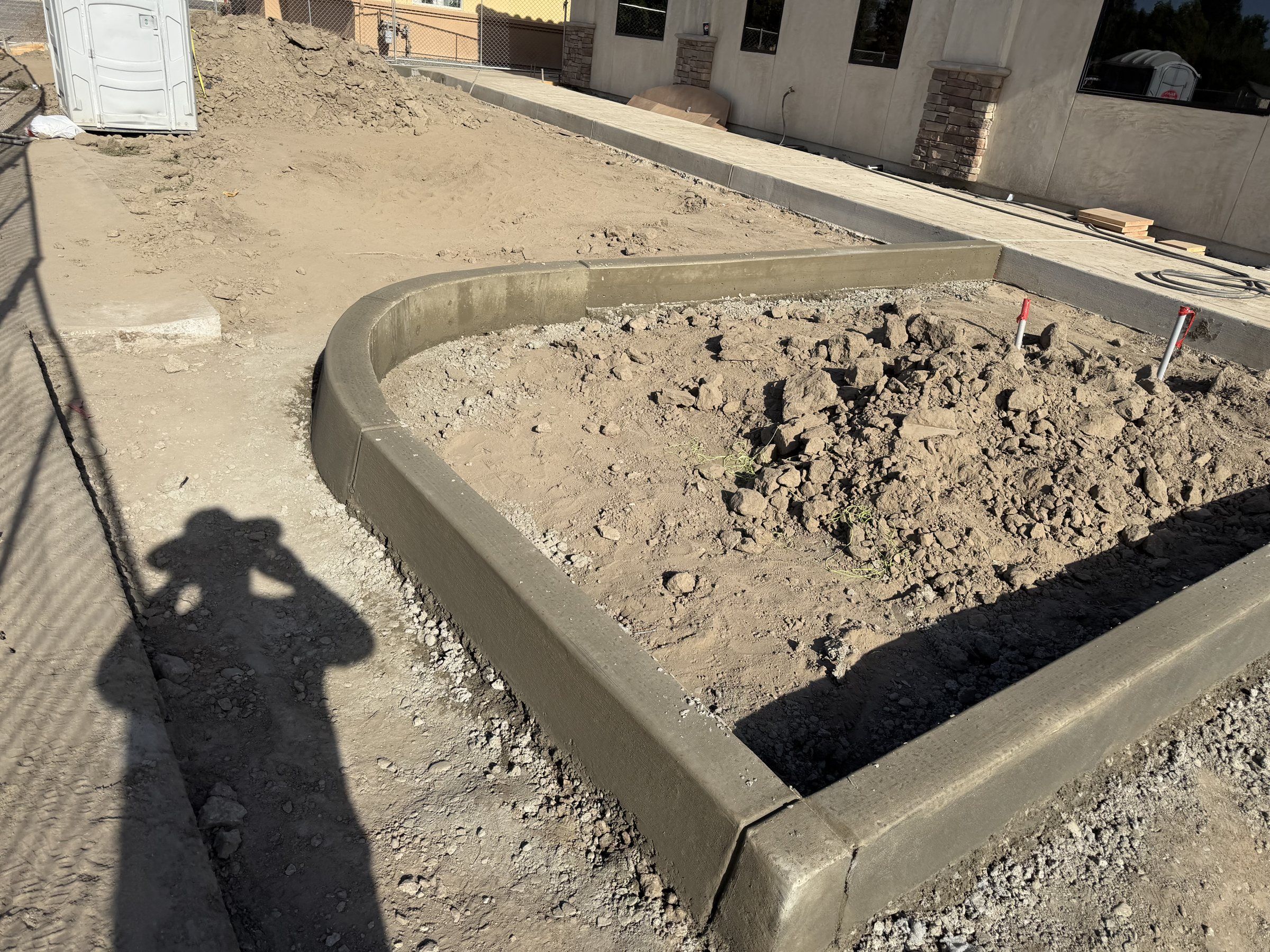 Concrete curb and walkway edge with a curved corner