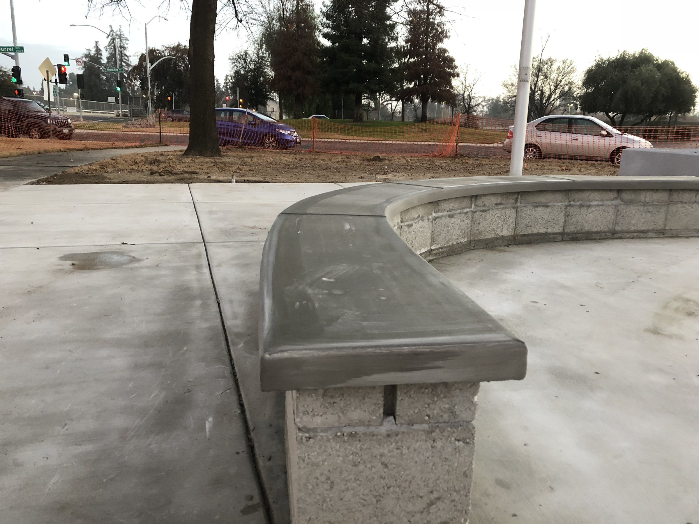 Close view of a curved concrete seat wall cap