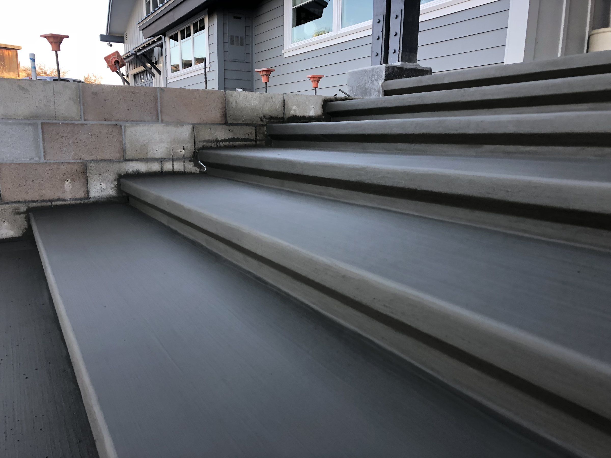 Wide poured concrete steps with smooth nosing