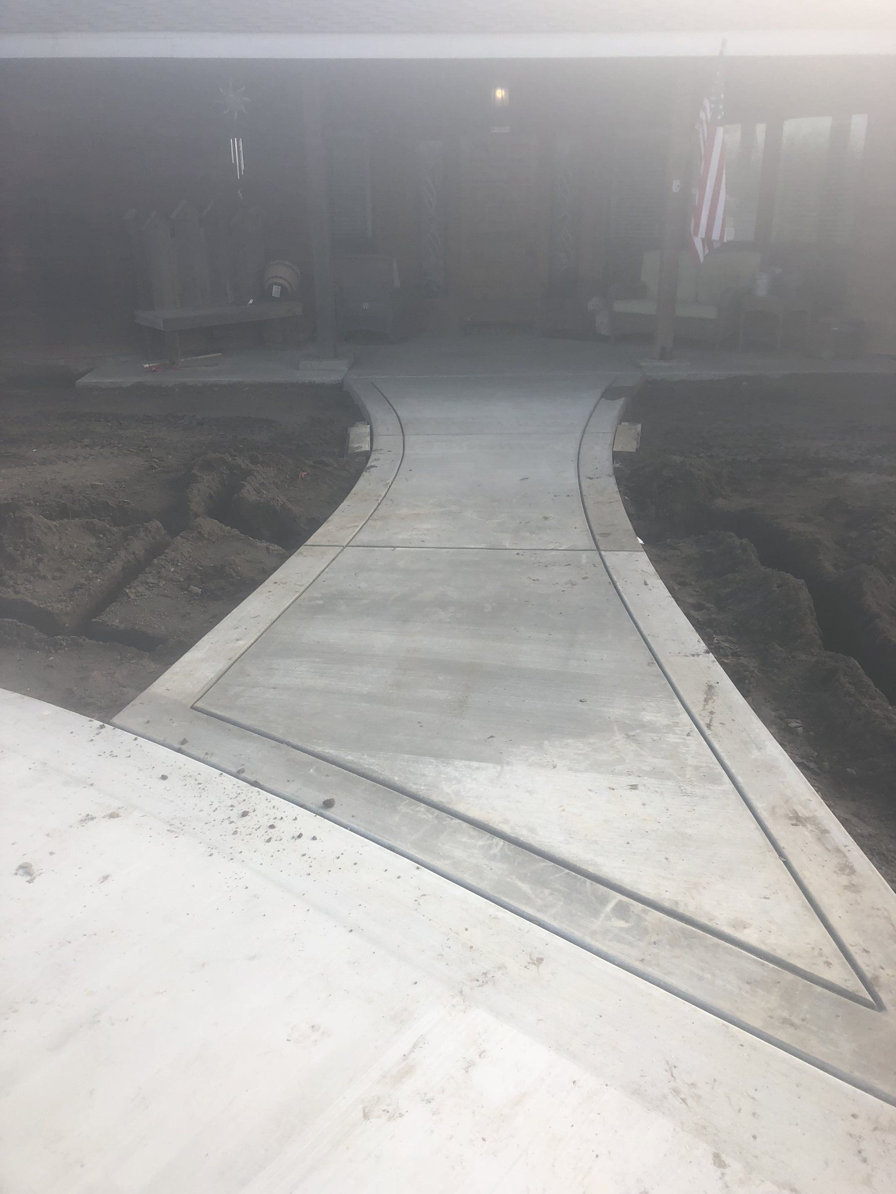 Flared concrete walkway with smooth border bands